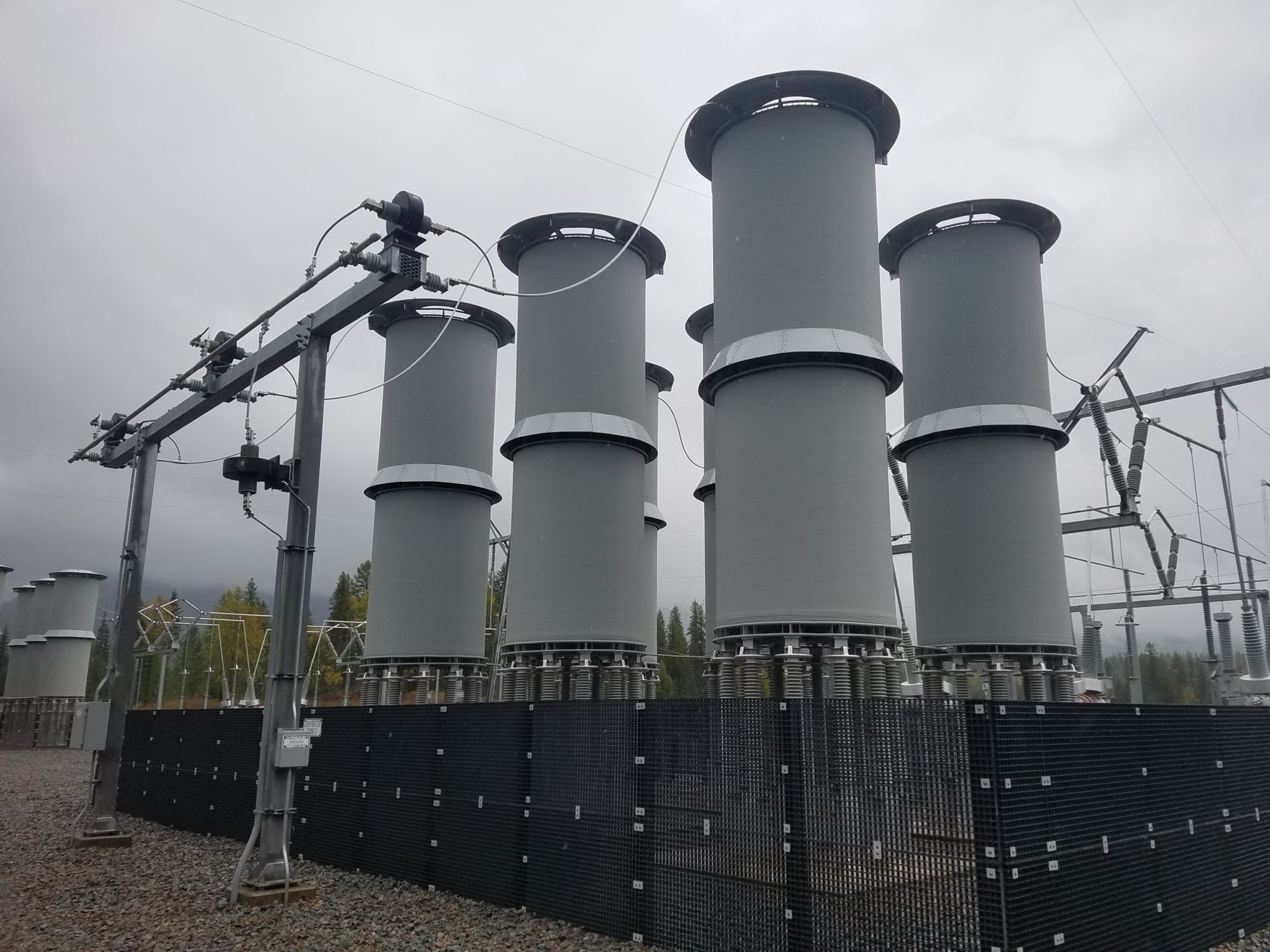 Air-core shunt reactor coils mounted on insulators at a substation.