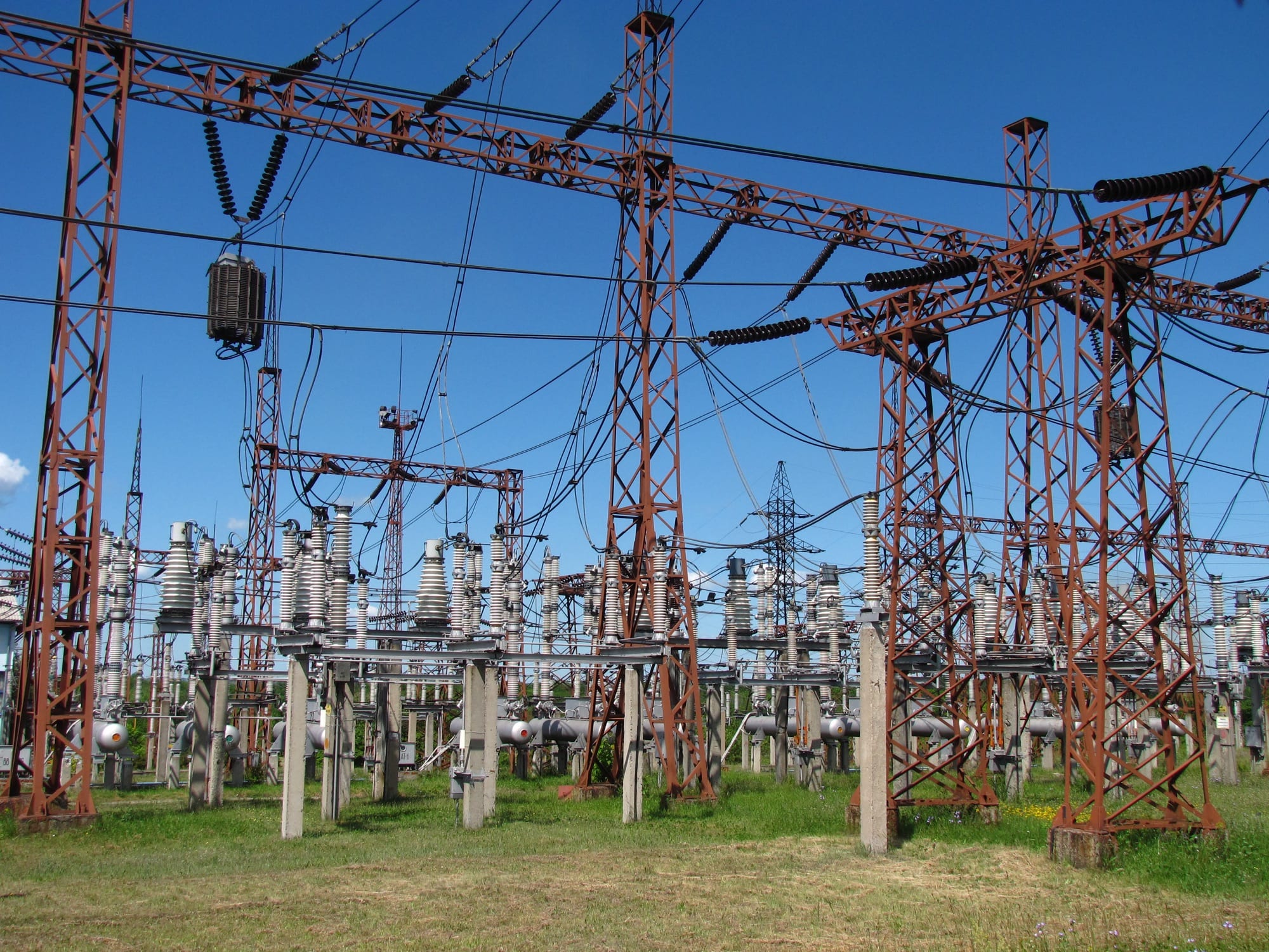 High-voltage switchgear in an outdoor substation, showing disconnectors and insulator stacks.
