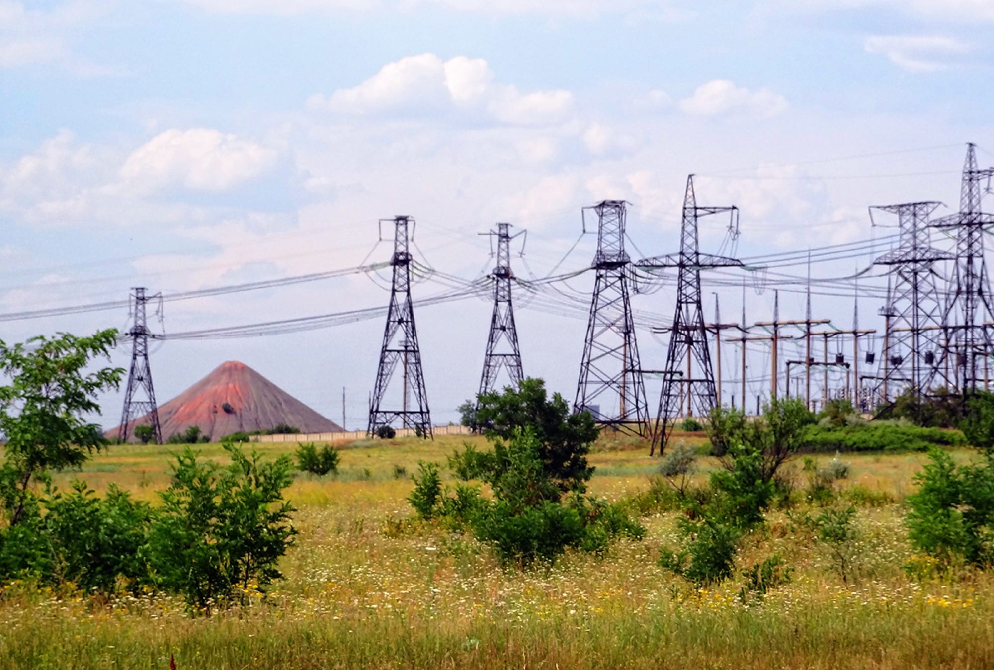 A 330 kV substation seen across its yard, showing busbars and gantries against the sky.